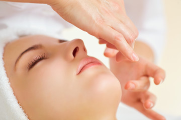 Wall Mural - beautiful woman at a facial massage at a spa salon.