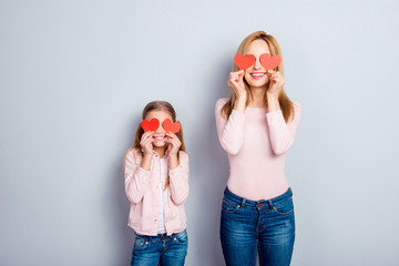 Canvas Print - Attractive, nice, cute, sweet, charming daughter and mom, mum standing over gray background, holding four small paper hearts on eyes place, smiling, having fun