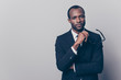 © deagreez - Portrait of confident discerning self-affured chief on a company dressed in black jacket and white shirt holding glasses in hand, isolated on gray background, copy-space