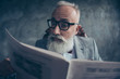 © deagreez - Serious, handsome, astonished, elderly, smart old businessman in glasses and jacket reading newspaper, shocked because of news about politic, bitcoin, finance, economy over gray background