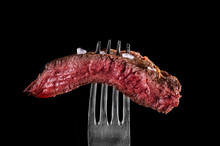Beef Meat Rare On Fork Black Background
