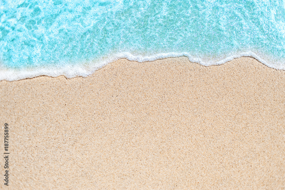 Background image of Soft wave of blue ocean on sandy beach.  Ocean wave close up with copy space for text. - obrazy, fototapety, plakaty 