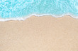 Background image of Soft wave of blue ocean on sandy beach.  Ocean wave close up with copy space for text.