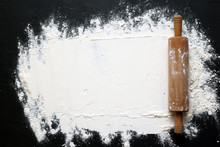 White Flour With A Rolling Pin On A Black Background