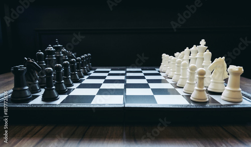Fotografía Beginning of the game, Two chess teams in front of different color white and bla