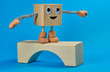 Wooden cube as a character holds balance on the bridge
