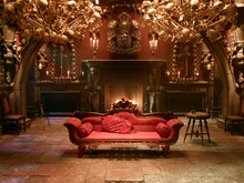 Bone Clad Living Room With Red Sofa And Open Fire