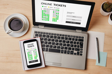 Wall Mural - online tickets concept on laptop and smartphone screen over wooden table. all screen content is desi