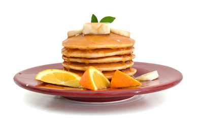 Wall Mural - Stack of pancakes with fresh orange and banana slice in plate on white