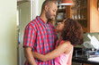 © Don Mason/Blend Images - Mixed race couple hugging in kitchen