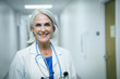 © FS Productions/Blend Images - Portrait of smiling female doctor standing in hospital