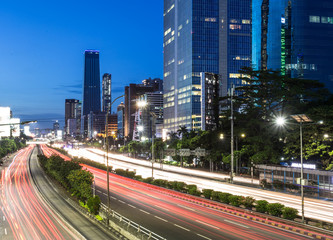 Poster - Traffic light trails in Jakarta business district in Indonesia capital city.