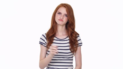 Poster - Displeased redhead young lady isolated over white wall background showing thumbs down