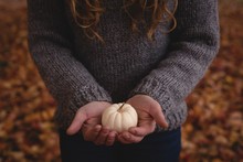 Woman Holding White Pumpkin During Autumn
