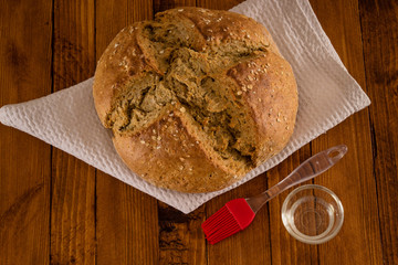 Traditional Irish Soda Bread Made For St. Patricks's Day, Pastry Brush And Oil Served On Wooden Table