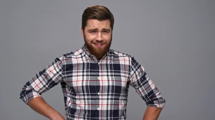 Sticker - Funny cool bearded man in shirt posing and looking at the camera over gray background