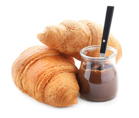 Yummy fresh croissants with chocolate paste on white background