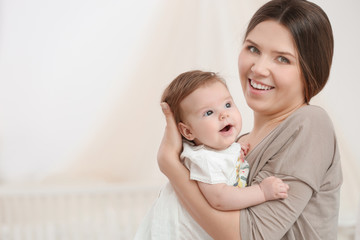 Sticker - Young mother with her cute little baby at home