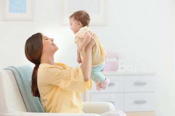 Sticker - Young mother with her cute little baby at home