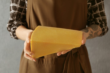 Wall Mural - Woman holding sliced cheese, closeup