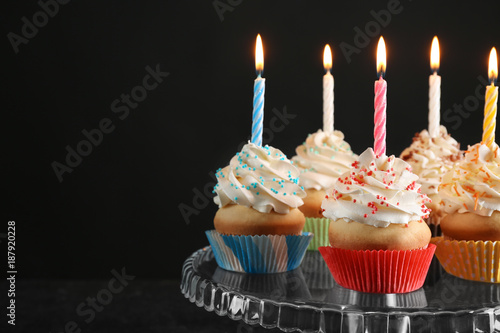 Birthday Cupcakes With Candles On Dessert Stand Against Black