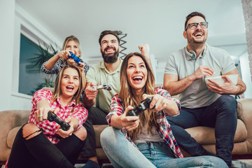 Wall Mural - Group of friends play video games together.