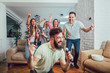© Mediteraneo - Group of friends playing karaoke at home. Concept about friendship, home entertainment and people