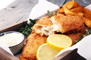 traditional British fish and chips with potato and lemon