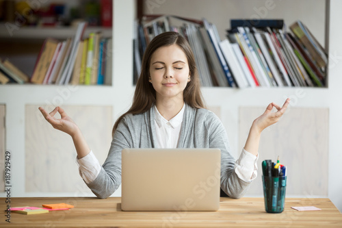 Fotografía Calm woman relaxing meditating with laptop, no stress free relief at work concep