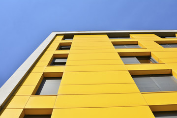 Yellow building with windows and blue sky