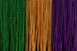 Green, gold, and purple Mardi Gras beads background