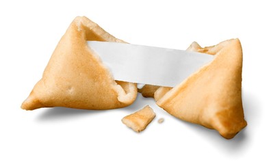broken fortune cookie with blank piece of paper