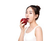 © ddukang - Happy healthy girl. Toothy smile portrait of a beautiful young woman, holding an apple, isolated on white.