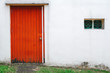 Old red door on a white wall. Background.