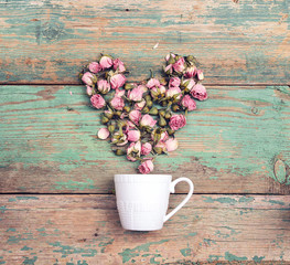 Poster - Coffee cup with heart from pink rose flowers coming out of it on old  turquoise wooden background. Top view. Flowers composition.