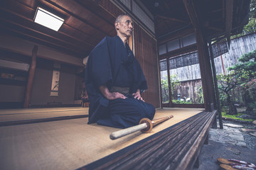 Wall Mural - Japanese man meditating in his garden