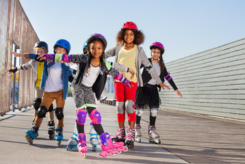 Wall Mural - Happy little roller skaters having fun outdoors