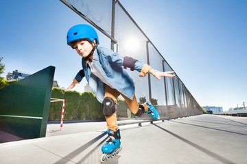 Wall Mural - Boy in roller blades doing tricks at skate park