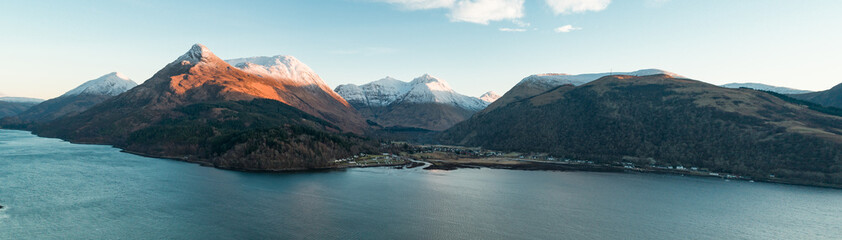 aerial view of glencoe and the mountains surrounding the small town in scotland