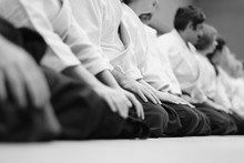 Sensei Students Sitting In A Row On The Mat At A Seminar On Aikido