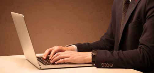 Businessman is suit working on laptop