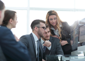 employees discussing financial charts