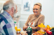 © Mediteraneo - Elderly couple in the kitchen preparing breakfast