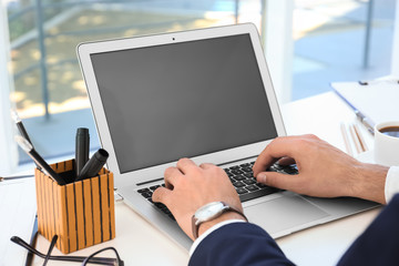 Sticker - Young businessman using his laptop while working in office