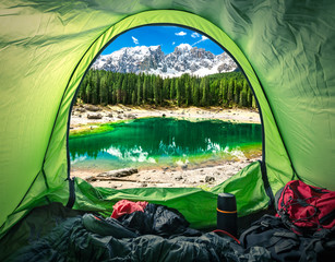 view from tent in mountain carezza lake, alps, italy, europe