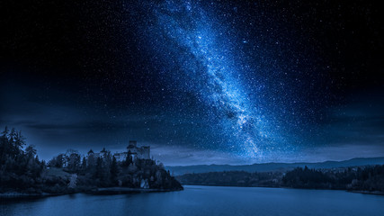 Wall Mural - beautiful castle by the lake at night with milky way