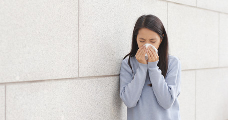 Wall Mural - Woman sneezing at outdoor