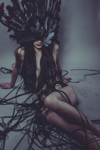 Nude Brunette Woman In A Headdress Made Of Big Feathers In Sensual And Mysterious Poses