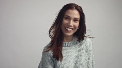 Wall Mural - happy wide smiling spanish woman portrait in studio on grey