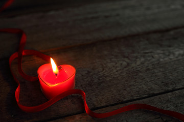 Heart shaped candle burning